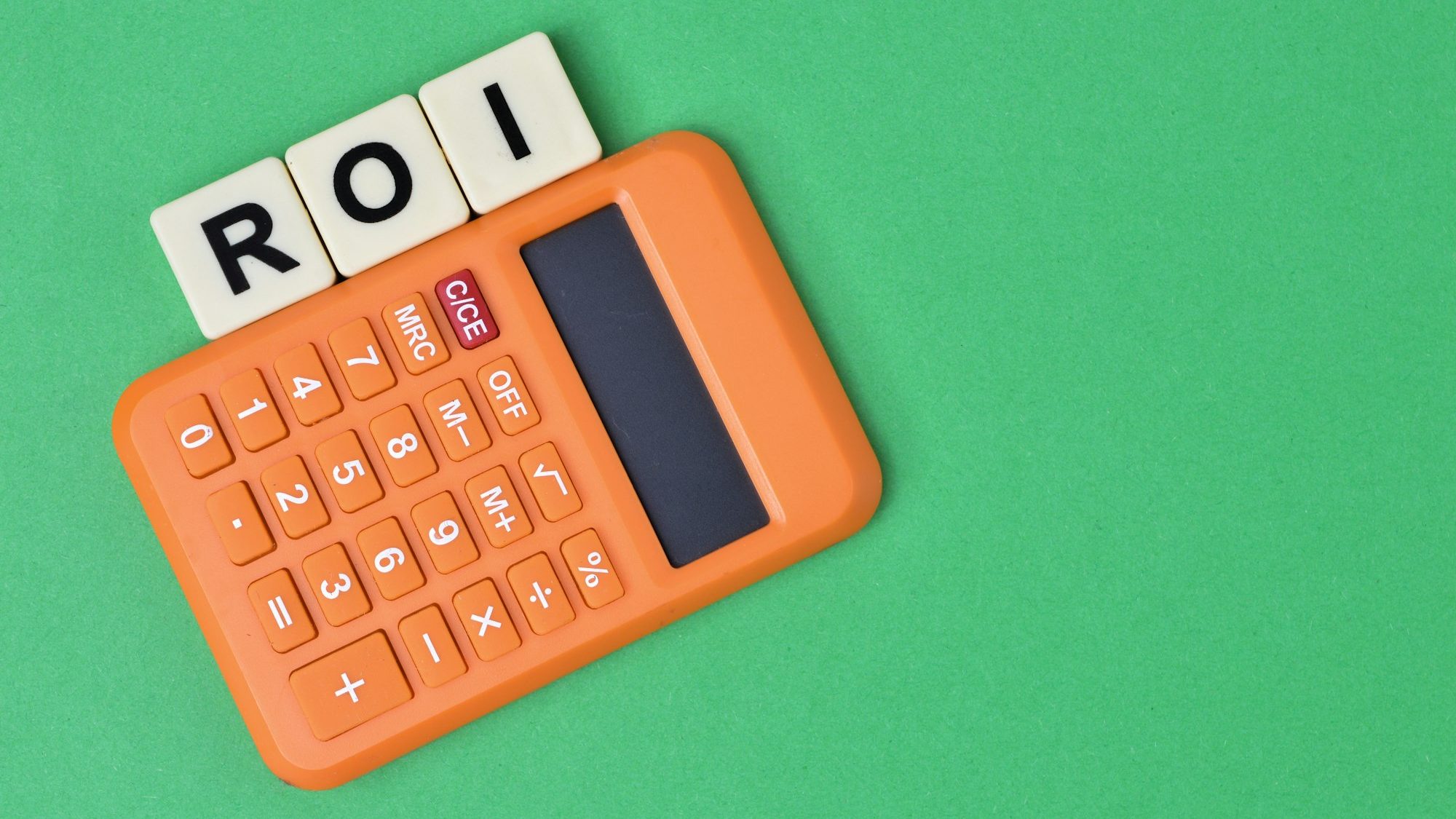 scrabble letters with text ROI stands for Return On Investment.