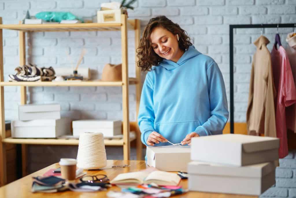 Small business owner, entrepreneur, seller using tablet checking ecommerce clothing store orders.