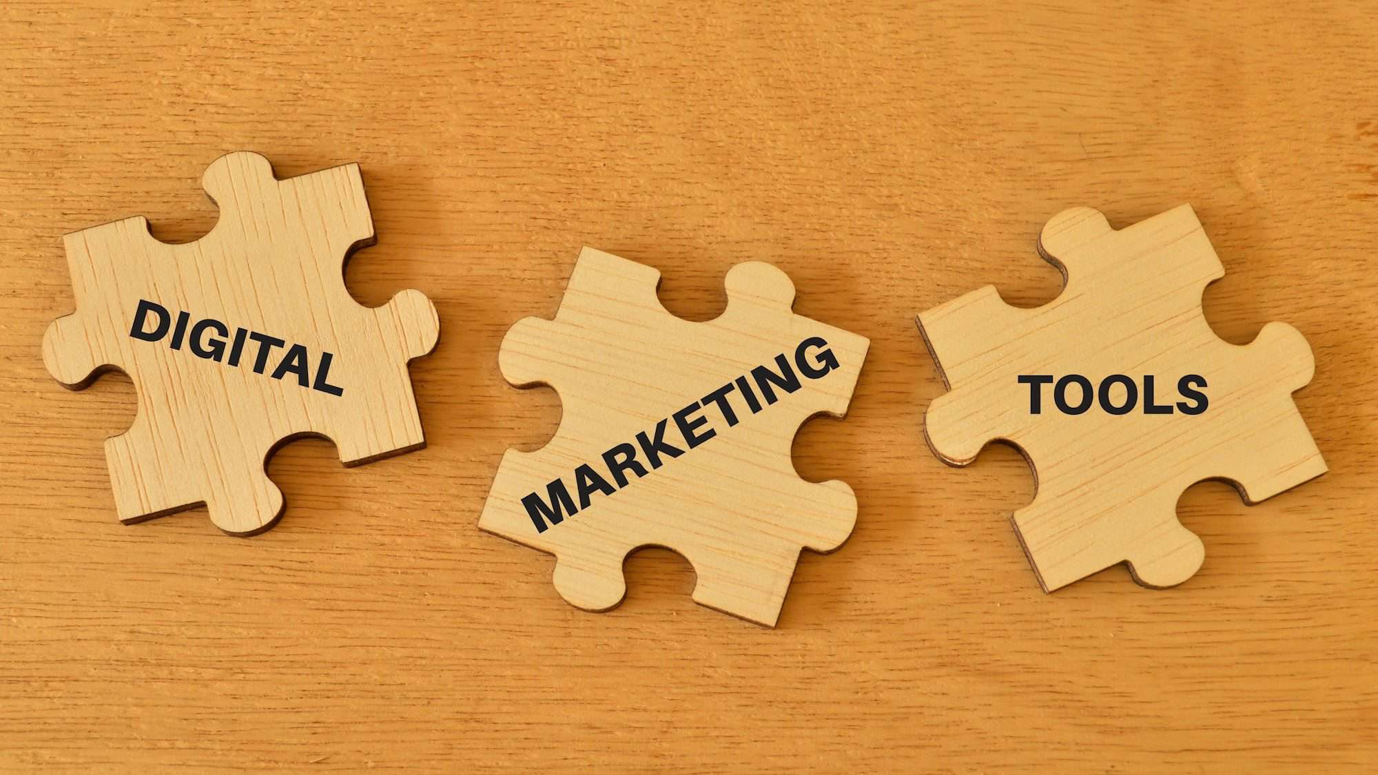 Wooden jigsaw puzzle with text DIGITAL MARKETING TOOLS for section on best seo tools for businesses